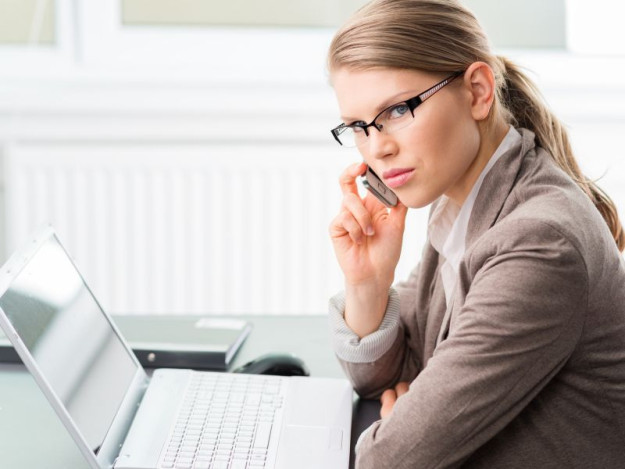 Woman on phone with laptop