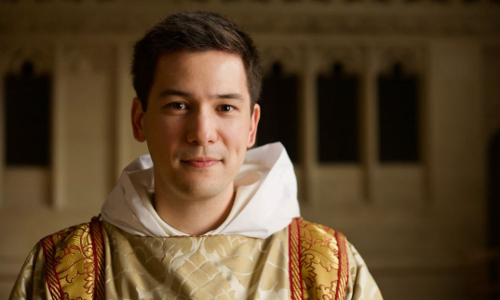 christian man in white and gold religious garb