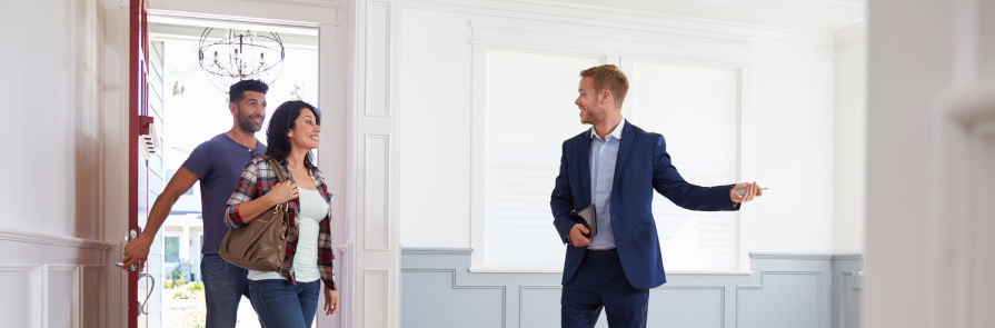 Real estate agent showing home to young couple