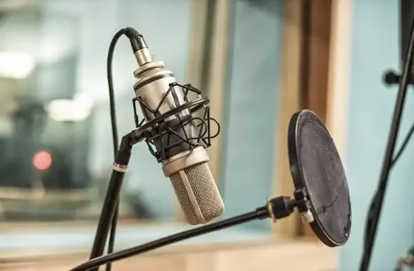 microphone and pop filter set up in a recording studio