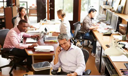 diverse business staff working in small shared office