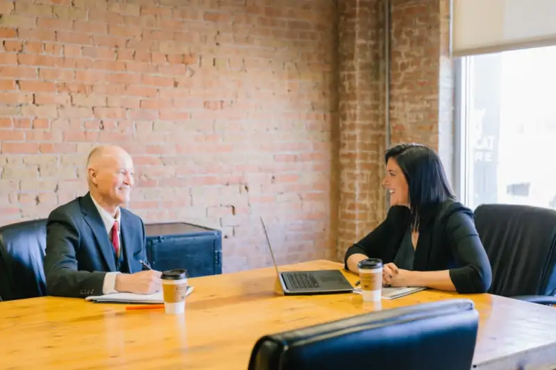 financial advisor working with client in meeting room