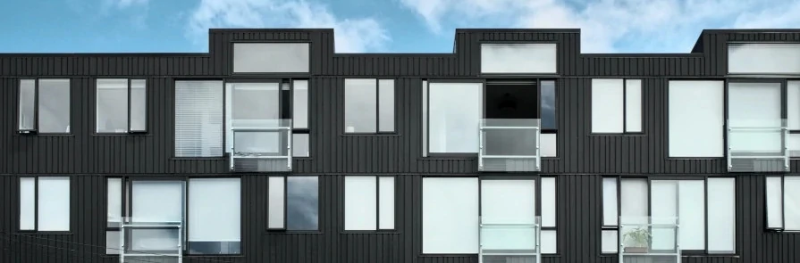 exterior of apartment building with blue sky in background