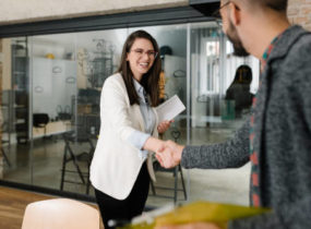 woman shaking hand of recruiter at interview