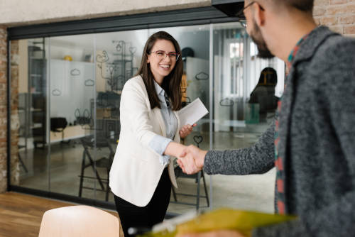 woman shaking hand of recruiter at interview