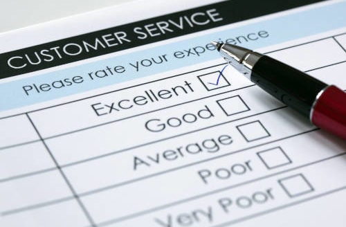 paper customer service survey with excellent checked in ink and a pen lying on top