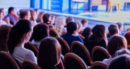 audience members sitting in a performing arts theatre